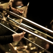 Hands of man playing the trombone in the orchestra
